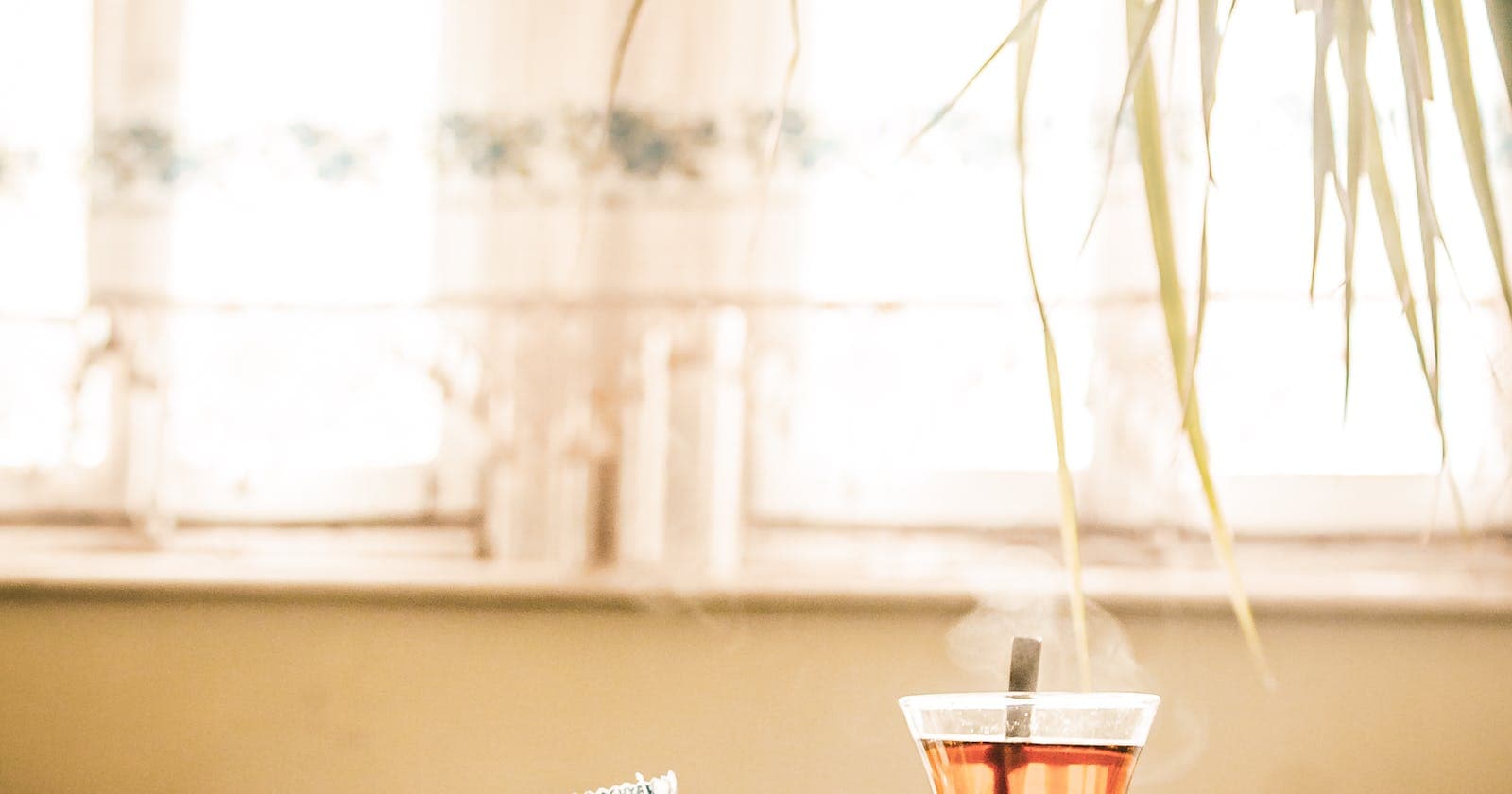 Cup of tea in sunlit window, clearing Kapha fog with warmth and light