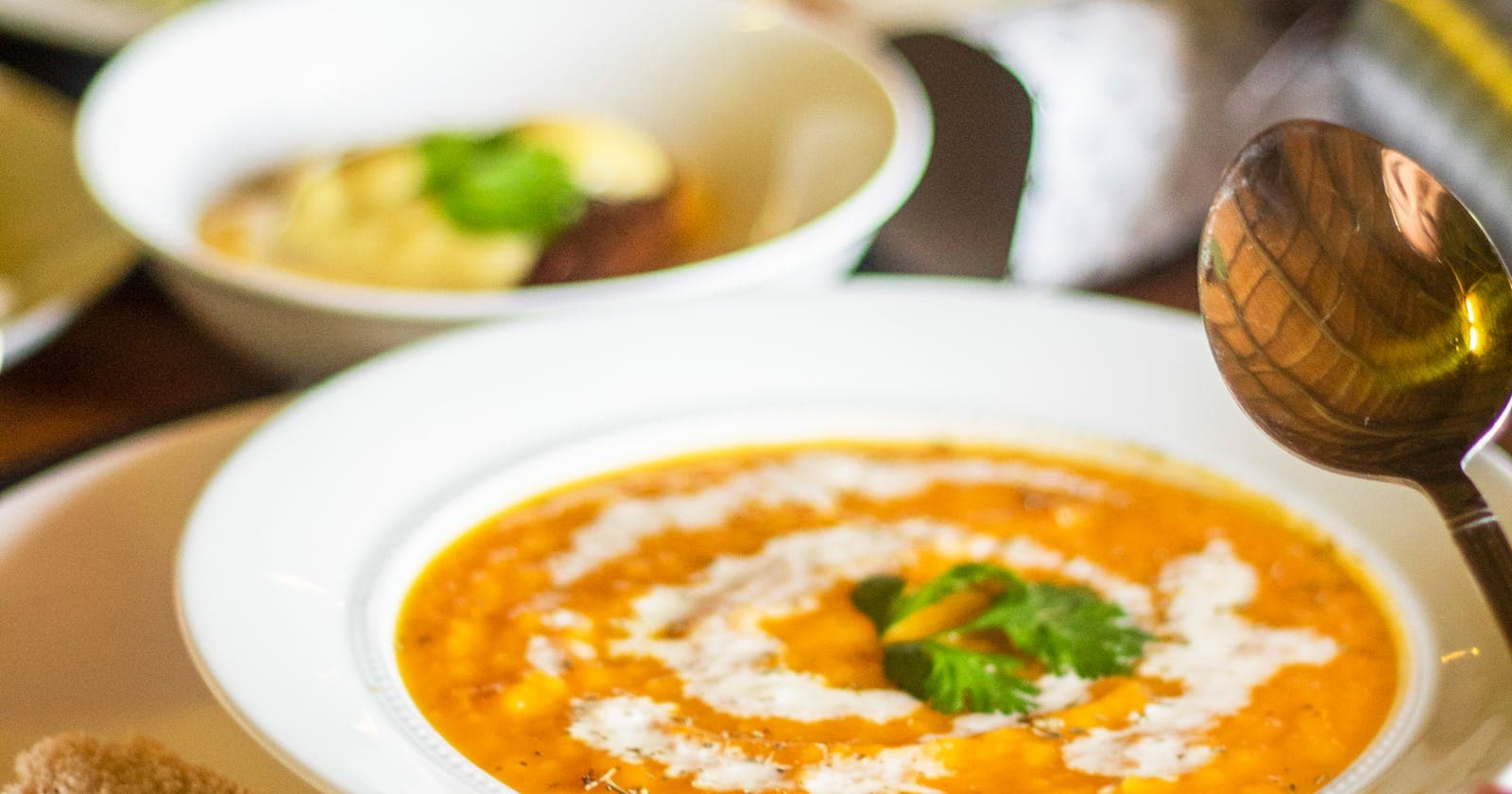 Spiced lentil soup with bread, lighter warmer meals lift Kapha heaviness