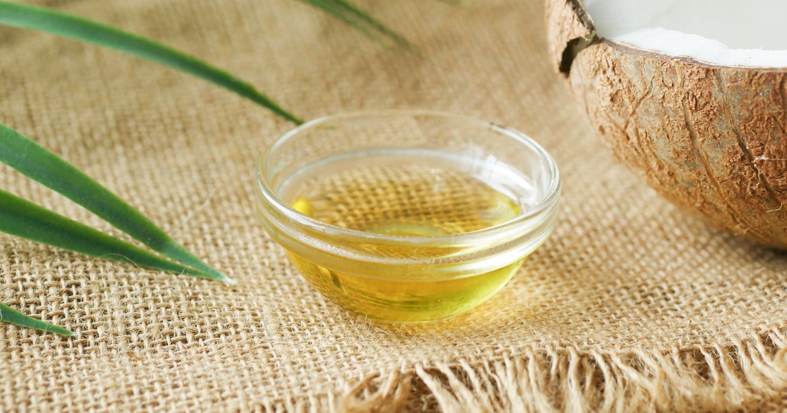 Coconut oil in a glass bowl on burlap, Pitta's cooling ally for hot months