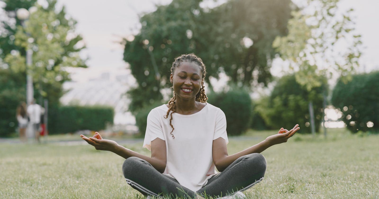 Woman meditating in a sunny park, beginning to know your own constitution