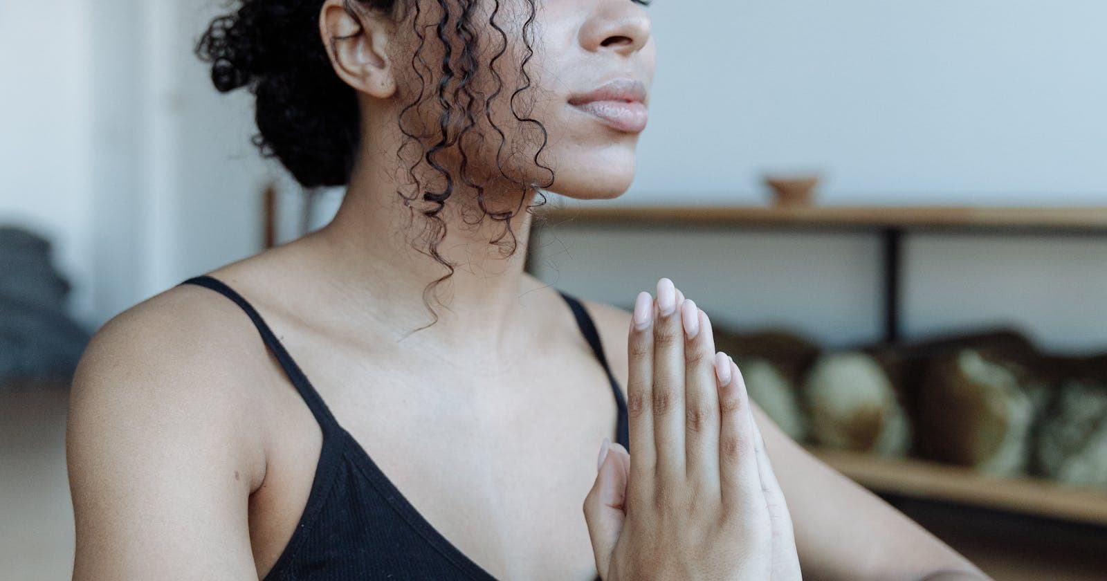 Soft indoor light on a meditating face, calming the racing Vata mind