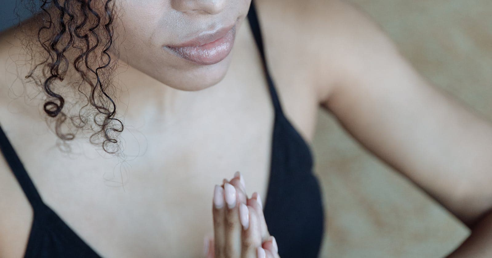 Hands joined in soft light — gratitude as a quiet practice
