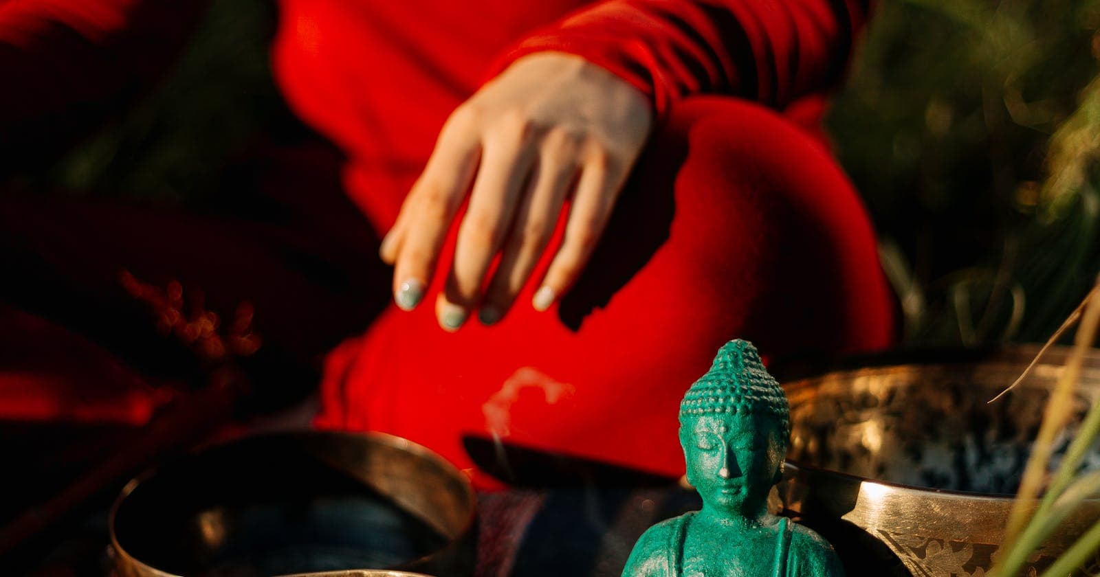 Woman with a Tibetan singing bowl in soft light — concentration practices like trataka