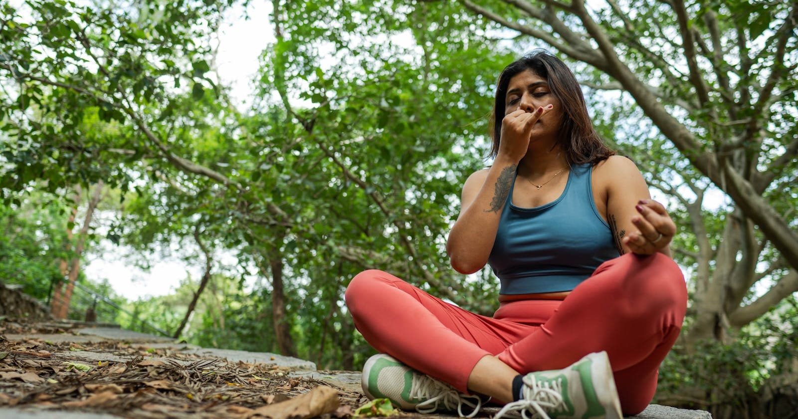 Woman walking and breathing in a forest — meditation that doesn't sit still