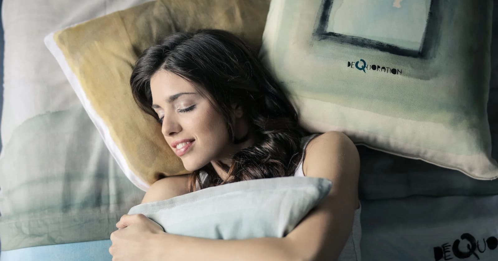 Woman lying peacefully on a pillow — yoga nidra, the sleep that isn't sleep