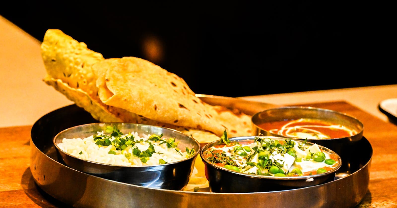 Traditional thali with naan, paneer curry and rice — the breadth of an Ayurvedic meal