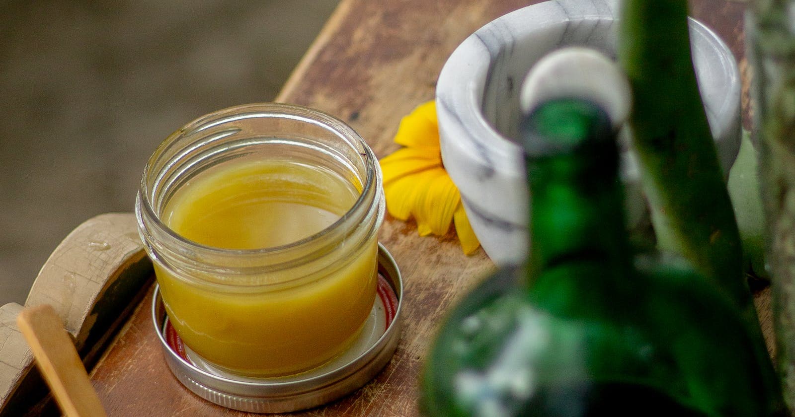 Herbal remedies and balms arranged on a wooden table — the herbal apothecary