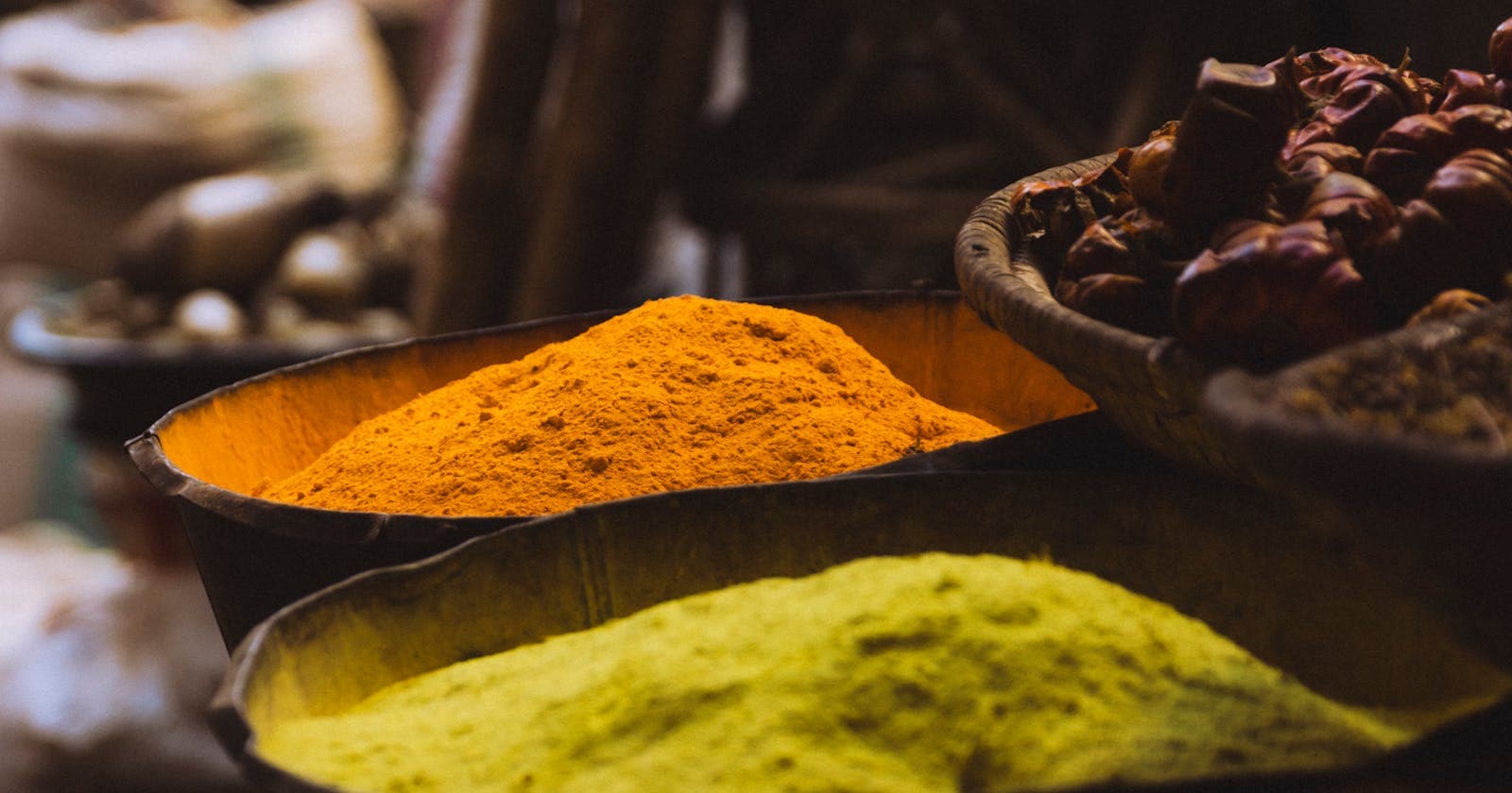 Vibrant spices in a traditional market — the everyday spice kit Ayurveda runs on