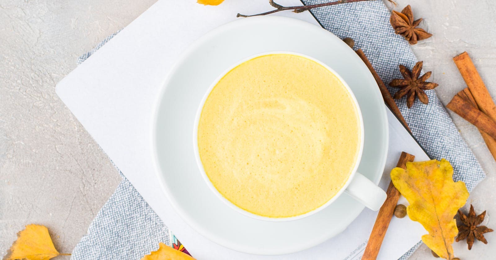 Warm turmeric latte with cinnamon and star anise — golden milk, the bedtime drink