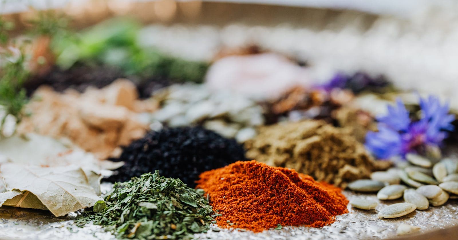 Bowl of spices in red, yellow and gold — the six tastes laid out