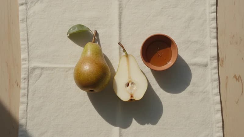 Pear (Amritaphala) — whole and prepared form, top-down still life